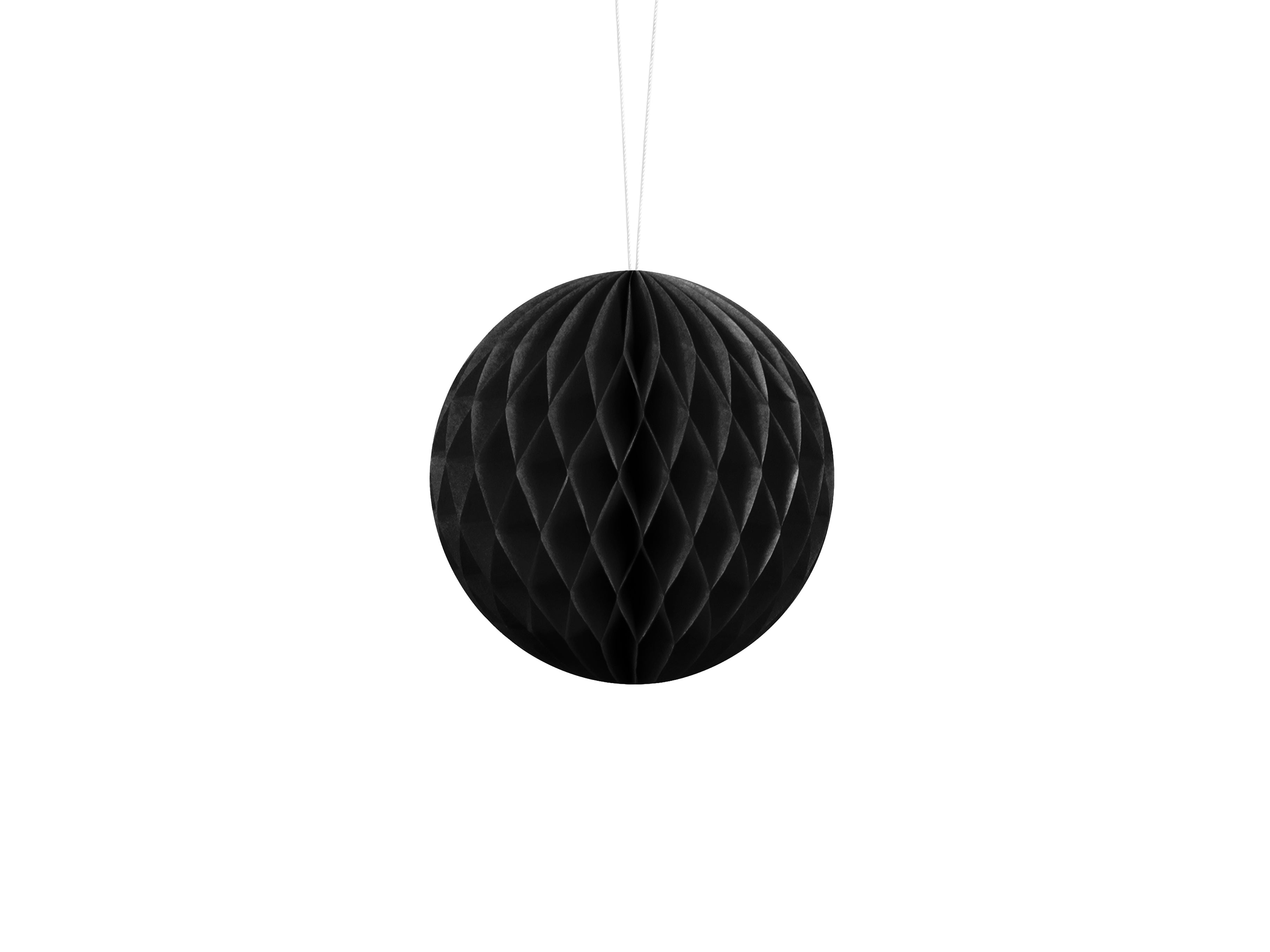 Black honeycomb ball hanging against a white background