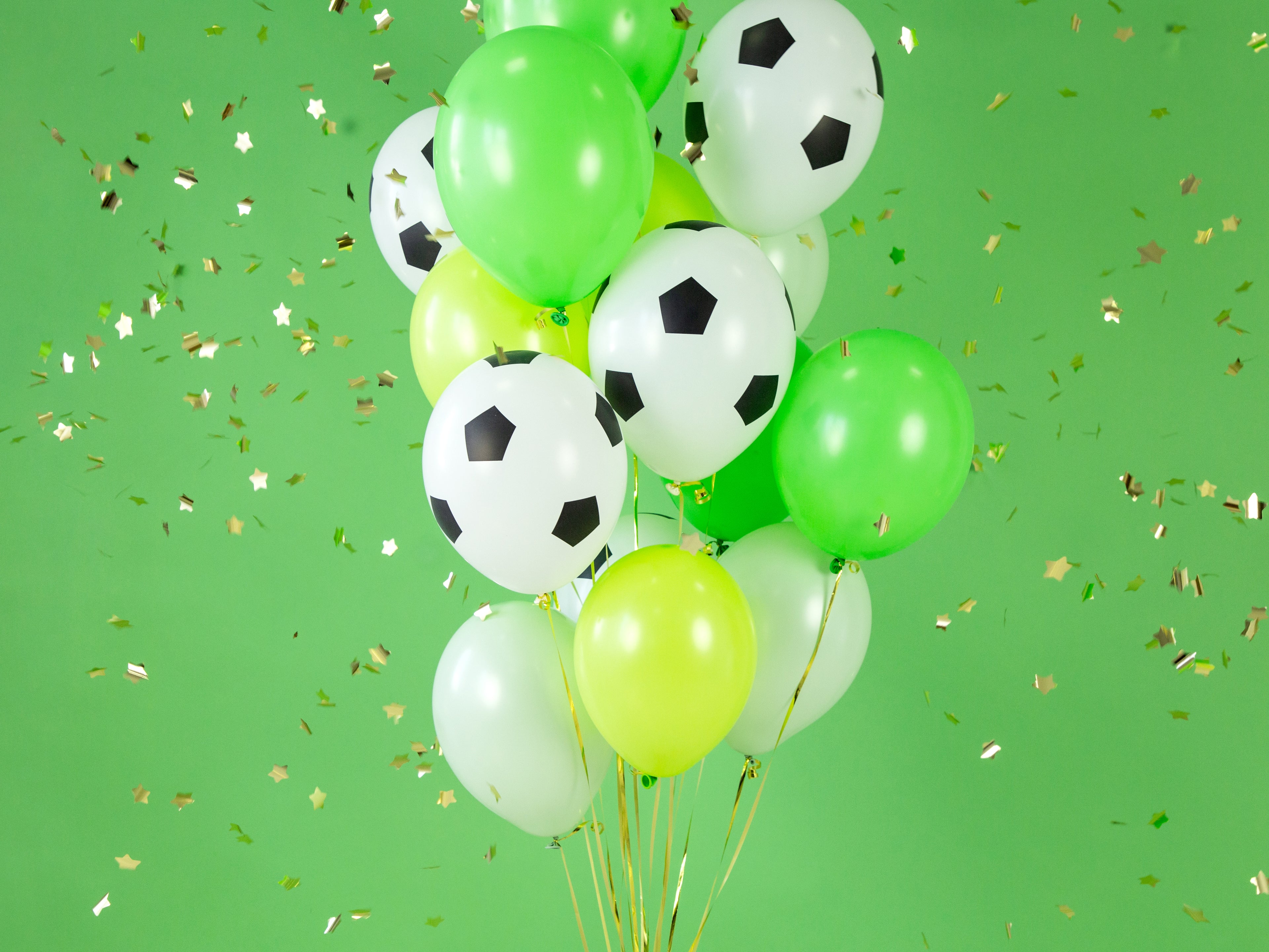 Bouquet of soccer-themed balloons with green, white, and black colors on a green background.