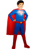 Child wearing a Superman costume with a red cape and blue suit on a white background